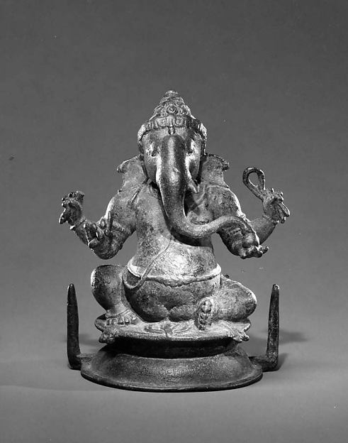 Chola-period bronze sculpture of the elephant-headed god Ganesha seated with four arms