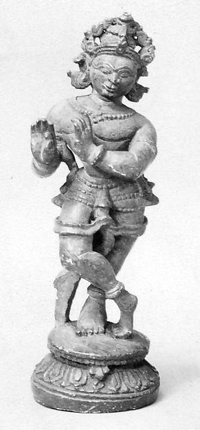 Stone sculpture of Krishna playing his bamboo flute